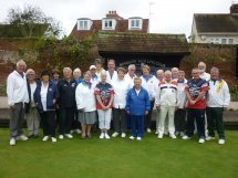 Group shot of both teams together, all smiles despite the weather.