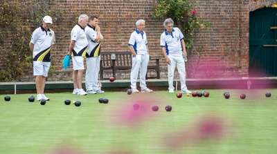 Peter Burgess and Paul Simmons in apprehensive mood as things tighten up  masked by the pink flowers in the flower  bed, neatly  captured by Tony Ketley.