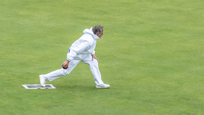 Greenkeeper Alan Steptoe in action and probably a little worried about the effect of so much rain on the green ?